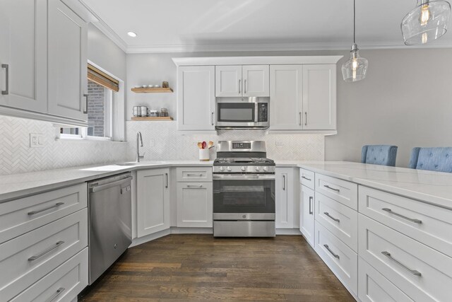 6351 N Glenwood Ave Unit 1S, Chicago, IL 60660 - kitchen featuring appliances with stainless steel finishes, crown molding, white cabinets, dark wood-type flooring, and backsplash