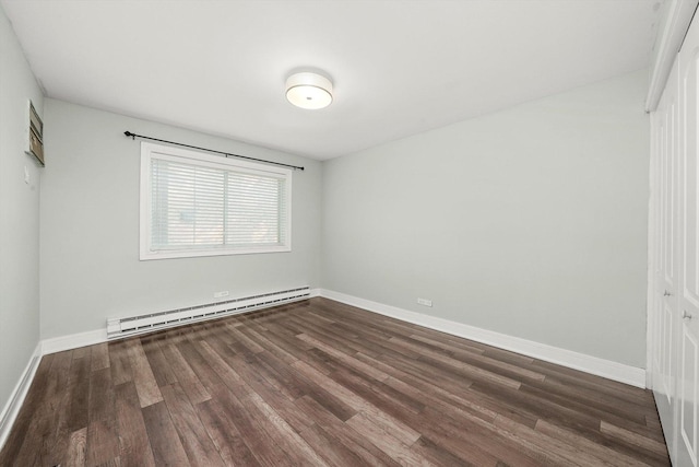 4113 W 97th Pl Unit 104, Oak Lawn, IL 60453 - unfurnished bedroom featuring baseboard heating, dark wood-type flooring, and a closet