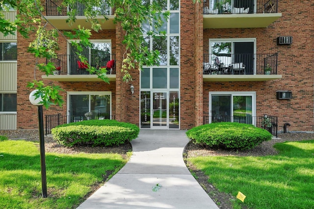 4113 W 97th Pl Unit 104, Oak Lawn, IL 60453 - property entrance featuring a balcony and brick siding