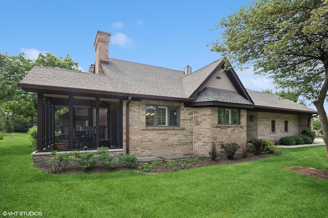 1709 Pebble Beach Ct, Hoffman Estates, IL 60169 - back of property featuring brick siding, a yard, a sunroom, and roof with shingles