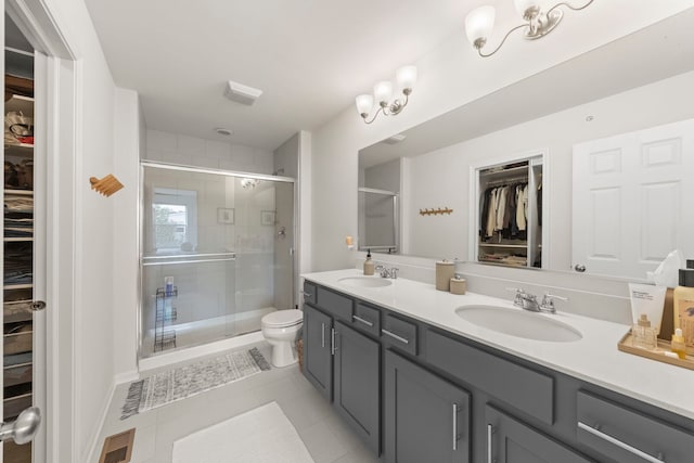 29W711 Cambridge St, Warrenville, IL 60555 - bathroom featuring a walk in closet, double vanity, a stall shower, and tile patterned flooring
