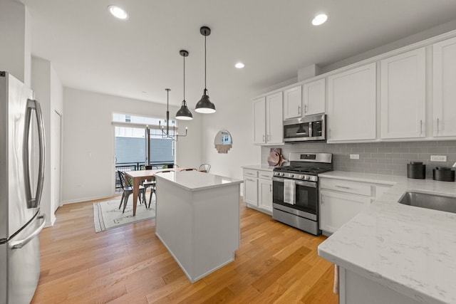 29W711 Cambridge St, Warrenville, IL 60555 - kitchen with stainless steel appliances, backsplash, light wood-type flooring, white cabinetry, and recessed lighting