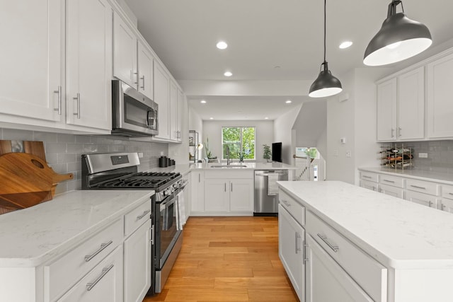 29W711 Cambridge St, Warrenville, IL 60555 - kitchen with stainless steel appliances, recessed lighting, a peninsula, light wood-style floors, and decorative backsplash