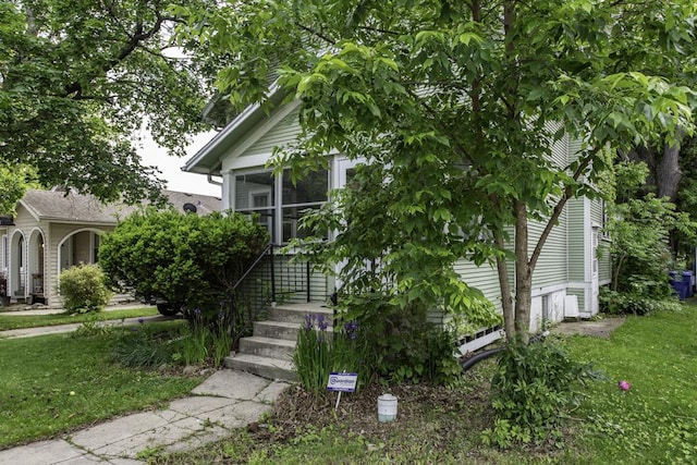 1502 Henry Pl, Waukegan, IL 60085 - obstructed view of property featuring a front lawn and a sunroom