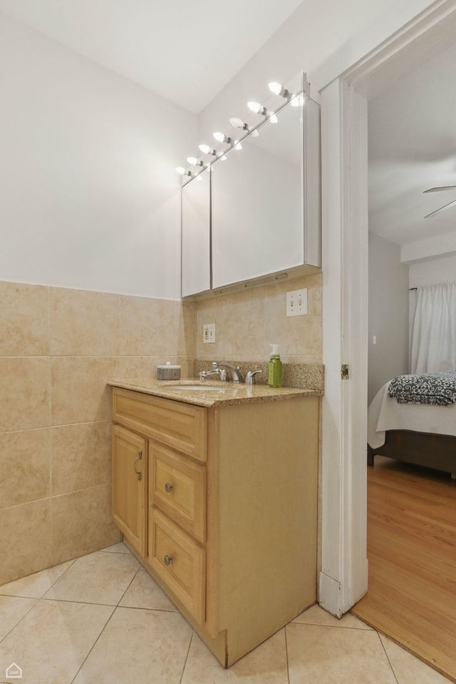 4857 N Drake Ave Unit G, Chicago, IL 60625 - bathroom with vanity, tile patterned flooring, tile walls, ceiling fan, and a wainscoted wall