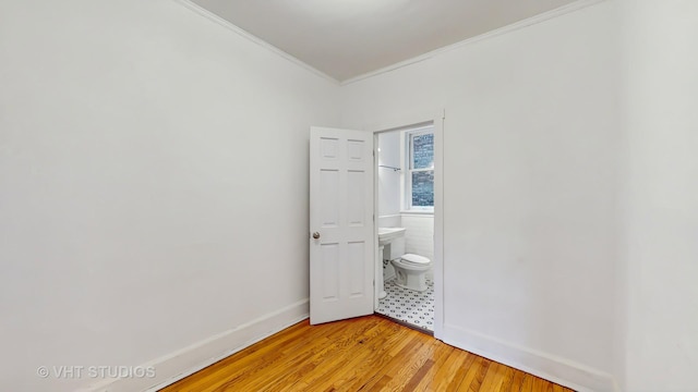 1646 E 54th St Unit 2, Chicago, IL 60615 - spare room with crown molding and light wood-style floors