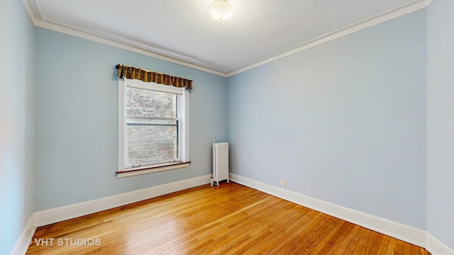 1646 E 54th St Unit 2, Chicago, IL 60615 - spare room featuring radiator, ornamental molding, and light wood-type flooring