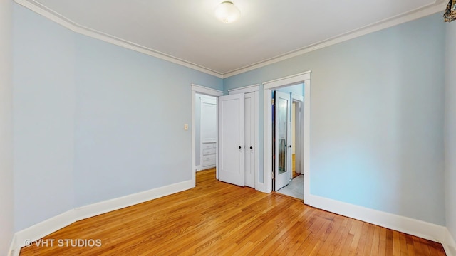 1646 E 54th St Unit 2, Chicago, IL 60615 - unfurnished bedroom with light wood finished floors, ornamental molding, and ensuite bath