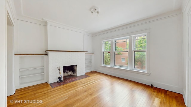 1646 E 54th St Unit 2, Chicago, IL 60615 - unfurnished living room with light wood-style floors, a fireplace, and built in features