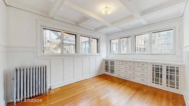 1646 E 54th St Unit 2, Chicago, IL 60615 - unfurnished room with radiator, a decorative wall, light wood finished floors, coffered ceiling, and beamed ceiling