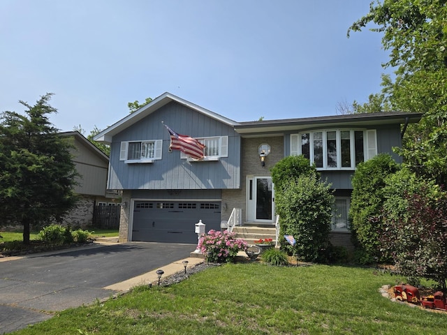 4910 143rd Pl, Midlothian, IL 60445 - raised ranch with brick siding, driveway, a garage, and a front lawn