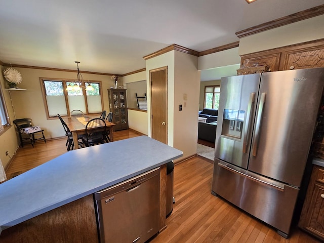 4910 143rd Pl, Midlothian, IL 60445 - kitchen featuring appliances with stainless steel finishes, crown molding, light wood finished floors, plenty of natural light, and decorative light fixtures