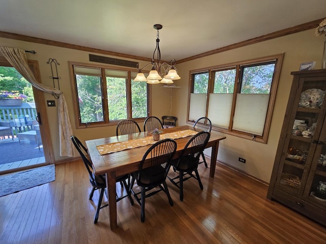 4910 143rd Pl, Midlothian, IL 60445 - dining space featuring hardwood / wood-style flooring, ornamental molding, baseboards, and a chandelier
