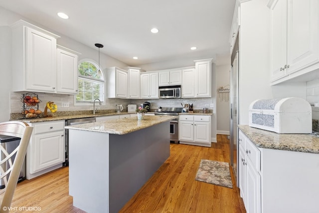 13008 Rockfish Ln, Plainfield, IL 60585 - kitchen with appliances with stainless steel finishes, white cabinetry, tasteful backsplash, and recessed lighting