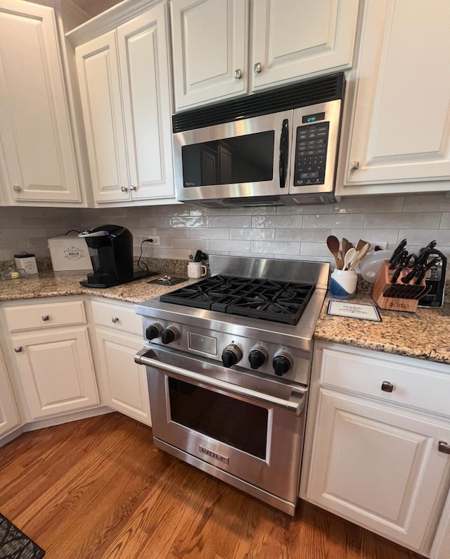 13008 Rockfish Ln, Plainfield, IL 60585 - kitchen with stainless steel appliances, white cabinetry, backsplash, and wood finished floors