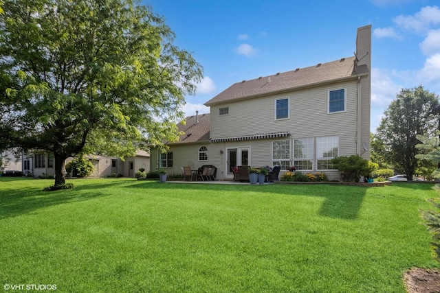 13008 Rockfish Ln, Plainfield, IL 60585 - rear view of house with a patio, a lawn, and a chimney