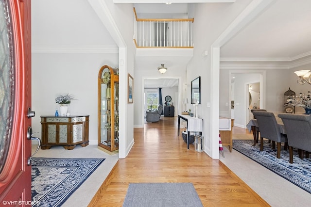 13008 Rockfish Ln, Plainfield, IL 60585 - foyer featuring a chandelier, light wood finished floors, and crown molding