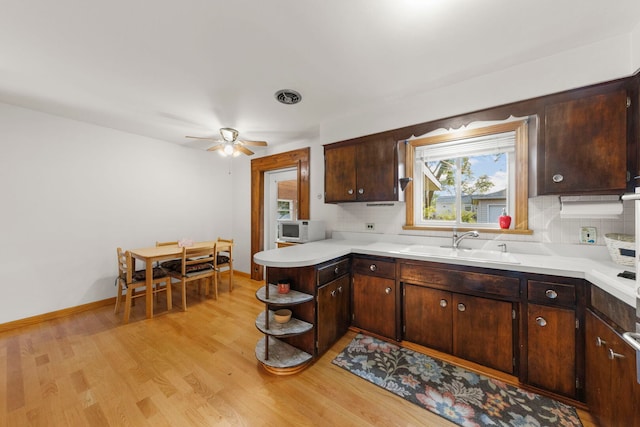 436 Marion St, Bensenville, IL 60106 - kitchen featuring white microwave, tasteful backsplash, and light wood-style flooring