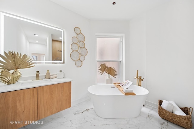 4752 S Champlain Ave, Chicago, IL 60615 - full bath with vanity, a freestanding bath, marble finish flooring, and baseboards