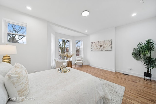 4752 S Champlain Ave, Chicago, IL 60615 - bedroom with multiple windows, wood finished floors, recessed lighting, and baseboards