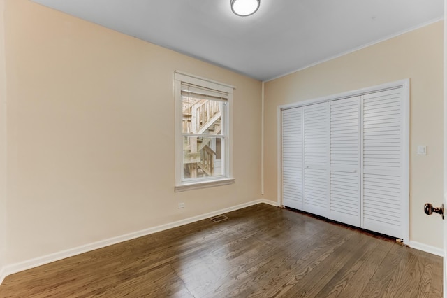 7955 S May St, Chicago, IL 60620 - unfurnished bedroom featuring dark wood finished floors, baseboards, a closet, and ornamental molding