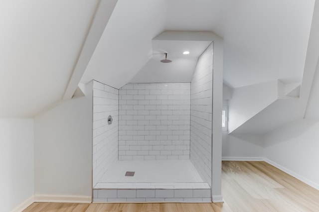 7955 S May St, Chicago, IL 60620 - bathroom featuring a tile shower, lofted ceiling, wood finished floors, and baseboards