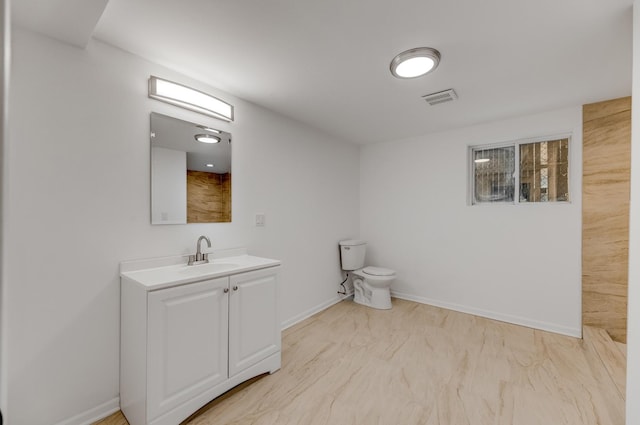 7955 S May St, Chicago, IL 60620 - bathroom featuring toilet, vanity, marble look tiles, and baseboards