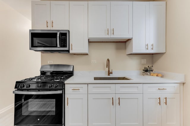 7955 S May St, Chicago, IL 60620 - kitchen with black range with gas stovetop, stainless steel microwave, a sink, and light countertops