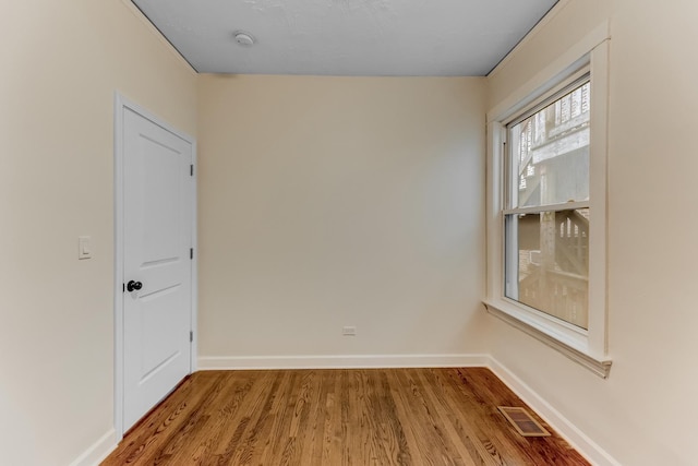 7955 S May St, Chicago, IL 60620 - empty room featuring wood finished floors, baseboards, and a smoke detector