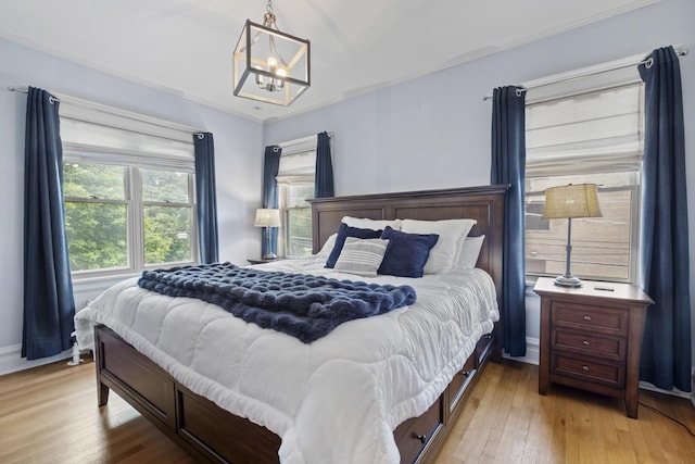 1419 W Birchwood Ave, Chicago, IL 60626 - bedroom with a chandelier, light wood-style flooring, and ornamental molding