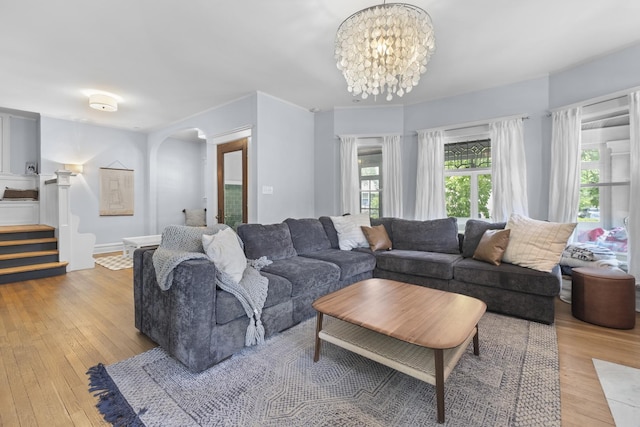 1419 W Birchwood Ave, Chicago, IL 60626 - living area featuring light wood-type flooring, stairway, arched walkways, and a chandelier