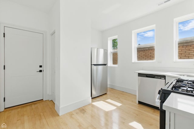 1928 W 21st St, Chicago, IL 60608 - kitchen with appliances with stainless steel finishes, light wood-style floors, and light countertops