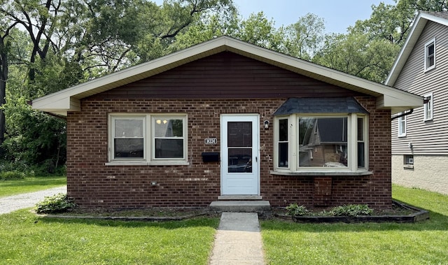 14334 Ridgeway Ave, Midlothian, IL 60445 - bungalow-style house with brick siding, a front lawn, and entry steps