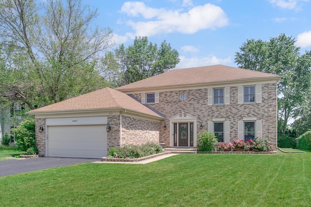 4227 N Walnut Ave, Arlington Heights, IL 60004 - view of front of property featuring a garage, brick siding, asphalt driveway, and a front yard