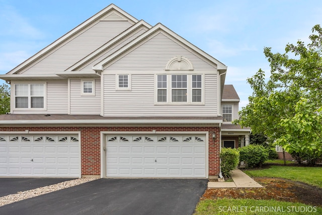 8609 Foxborough Way, Joliet, IL 60431 - view of front of house with asphalt driveway, brick siding, and a garage