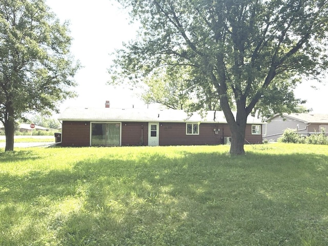 26048 S Dixie Hwy, Crete, IL 60417 - rear view of house with a lawn and a chimney