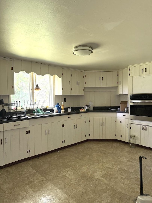 26048 S Dixie Hwy, Crete, IL 60417 - kitchen with oven, dark countertops, and tile patterned floors
