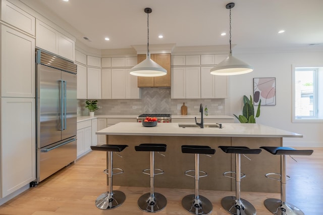 1016 N Hermitage Ave Unit 1, Chicago, IL 60622 - kitchen featuring stainless steel built in refrigerator, a sink, decorative backsplash, light countertops, and light wood finished floors