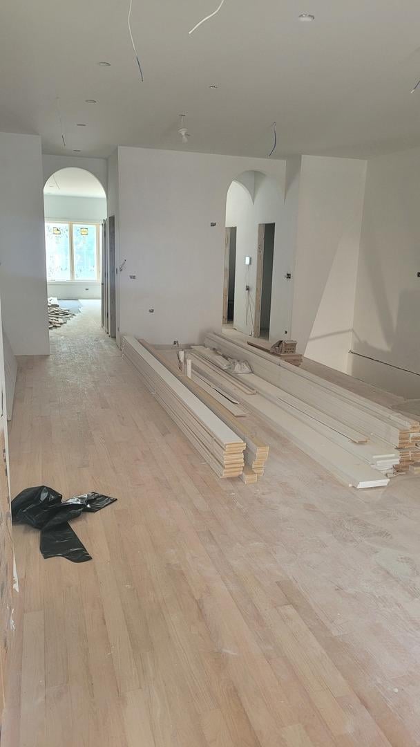 1016 N Hermitage Ave Unit 1, Chicago, IL 60622 - empty room featuring arched walkways and wood finished floors