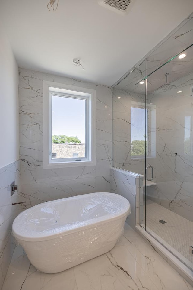 1016 N Hermitage Ave Unit 1, Chicago, IL 60622 - full bath with plenty of natural light, a marble finish shower, marble tiled flooring, and tile walls