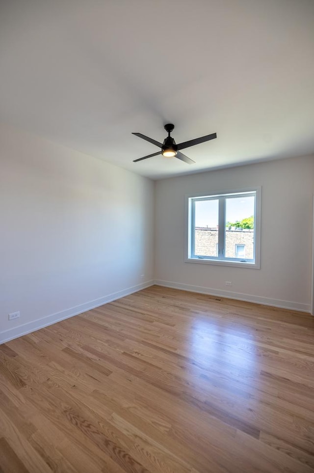 1016 N Hermitage Ave Unit 1, Chicago, IL 60622 - spare room featuring light wood-style floors, ceiling fan, and baseboards