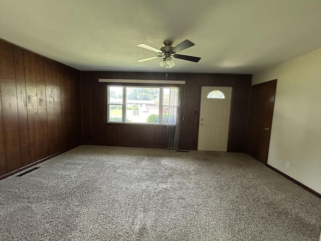 2100 Steven St, Rock Falls, IL 61071 - entrance foyer with wood walls, a ceiling fan, carpet flooring, and baseboards