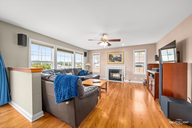 431 Blue Ridge Ct, Oswego, IL 60543 - living room with a ceiling fan, light wood-type flooring, plenty of natural light, and a tiled fireplace