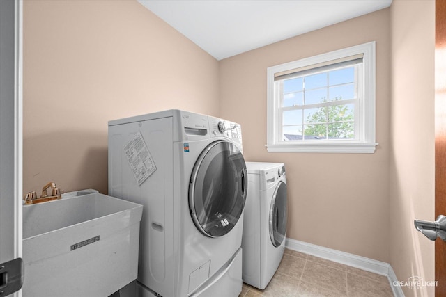 431 Blue Ridge Ct, Oswego, IL 60543 - laundry area featuring washer and dryer and light tile patterned floors