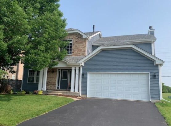 431 Blue Ridge Ct, Oswego, IL 60543 - view of front of property featuring asphalt driveway, an attached garage, a chimney, and brick siding