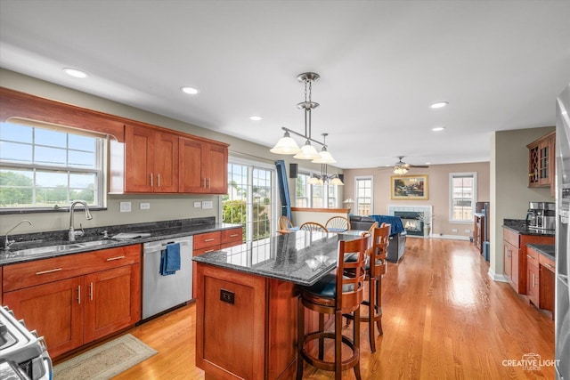 431 Blue Ridge Ct, Oswego, IL 60543 - kitchen with appliances with stainless steel finishes, open floor plan, light wood-style floors, a kitchen breakfast bar, and a center island