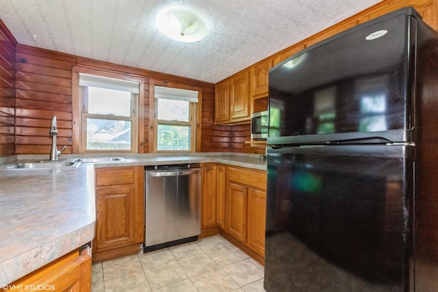 509 Sherman Ave, Aurora, IL 60505 - kitchen featuring appliances with stainless steel finishes, light countertops, light tile patterned flooring, brown cabinets, and an ornate ceiling