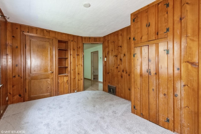 509 Sherman Ave, Aurora, IL 60505 - unfurnished bedroom with wood walls and carpet floors