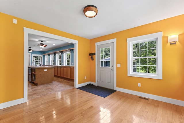 1046 N Riverside Dr, Momence, IL 60954 - foyer with light wood-style floors and ceiling fan