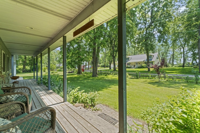 1046 N Riverside Dr, Momence, IL 60954 - wooden porch featuring a lawn and view of wooded area